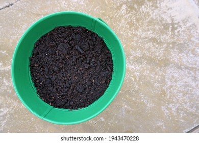 
Top View Of Green Flower Pot Filled With Moist Soil.