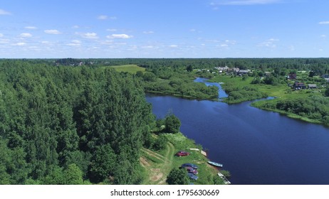 Top view of green forest with rivers and village on background horizon with blue sky. Shot. Beautiful summer landscape with green forest and blue rivers - Shutterstock ID 1795630669