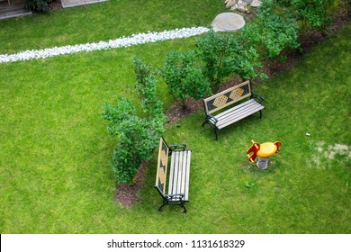 Top View Green Garden With Bench And Kid Horse Swing