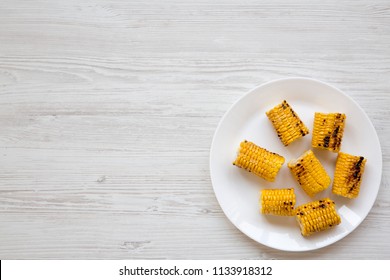 Top View, Grilled Corn On The Cob On Round White Plate Over White Wooden Background. Summer Food. From Above, Overhead. Copy Space.