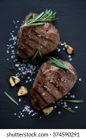 Top View Of Grilled Filet Mignon Steaks, Black Wooden Surface