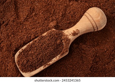 Top view of ground coffee and wooden scoop - Powered by Shutterstock