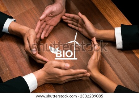 Top view group of business people forming circle hand together around eco-friendly bio fuel icon on meeting table. Alternative energy with Bio technology for greener and sustainable future. Quaint