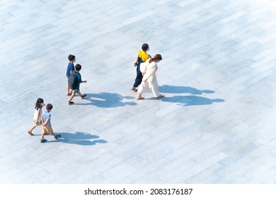 Top view of group family mothers and kids walking at pedestrian walkway outdoor for traveling or exercise healthy. Crowd people at background landscape public street in city. Girl and boys are funny. 