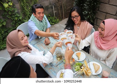 Top View Of A Group Friends Having Tea Toast At Table Dining During Ramadan Celebration