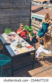 Top View Of Group Of Friends Talking And Drinking At A Party On A Terrace