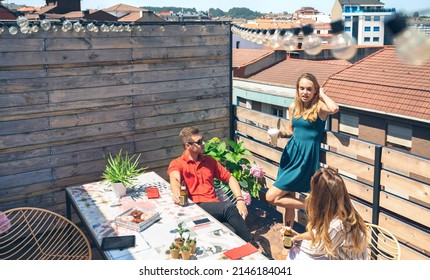 Top View Of Group Of Friends Talking And Drinking At A Party On A Terrace