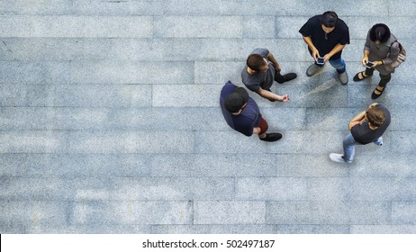 Top View Group Of People Are Playing And Talking With The Smart Phone On The Concrete Pedestrian (Aerial View)