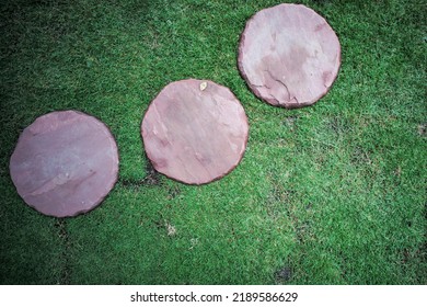 Top view group of sand stones in round shape place on the lawn field at the outdoor garden