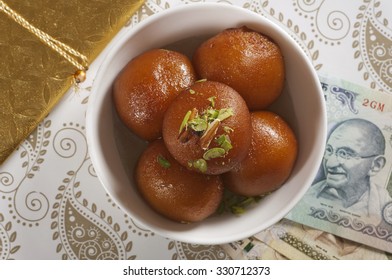 Top View Of Gulab Jamun And Currency