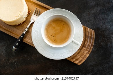 A Top View Of Half Empty Cup Of Coffee Latte On A Wooden Plate