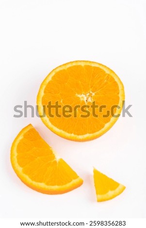 Top view of half orange, a slice and a segment on white background. Copy space. Concept of fruit and healthy eating