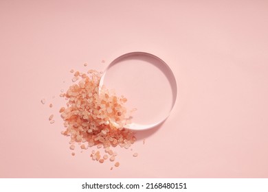 Top view of halit himalaya salt decorated with petri dish in pink background 