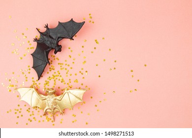 Top View Of Halloween Decoration With Plastic Bats Over Pink Background. Party, Invitation, Halloween Decoration Concept