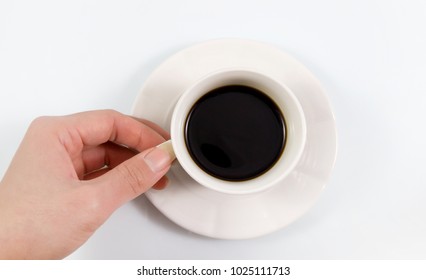 Top View, Hand Holding Of A Espresso Coffee In White Cup Isolated On White Background.