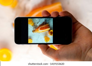 Top View Of Hand Holding A Phone Doing A Mobile Food Photography