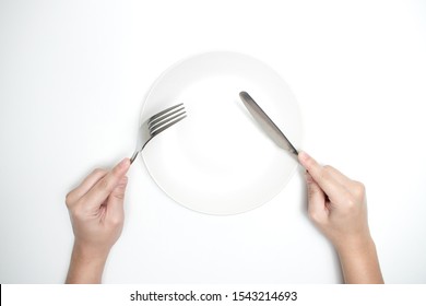 The Top View Of The Hand Holding A Spoon And Knife,
Dining Equipment. Isolated Background