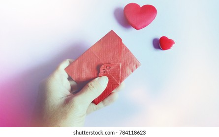 Top view Hand send red envelope on the day of love