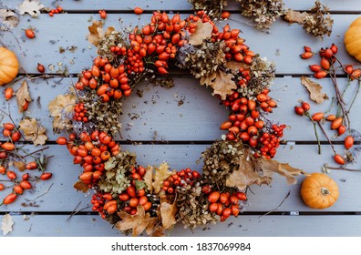 Top View Of Handmade Colorful Floral Autumn Door Wreath Made Of Colorful Rosehip Berries, Rowan, Dry Flowers And Oak Leaves. Fall Flower Decoration Workshop.. 