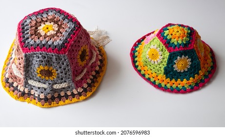 Top View Handmade Product To Make Spring Present, Colorful Bucket Hat With Many Piece Link Together, Cute Crochet Hat From Yarn On White Background