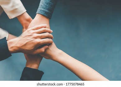 Top View Hands Of Business People Come Together In A Stack Of Hands To Symbolize Collaboration, Teamwork To Achieve Goals And Success.