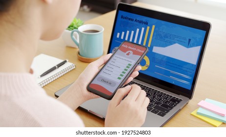 Top View Hands Holding Mobile Phone In Employee Self Assessment By Daily Health Check In Questionnaire Before Start Work In Coronavirus Pandemic Outbreak Work From Home Or Anywhere Concept.