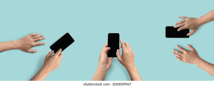 Top view of hands touching screen on mobile phone isolated on solid color background. of free space for your copy, view from top. - Shutterstock ID 2050039967