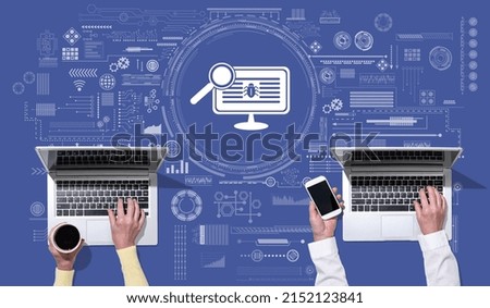 Top view of hands using laptop with symbol of software testing concept