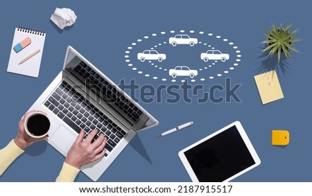 Top view of hands using laptop with symbol of connected cars concept