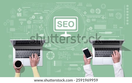 Top view of hands using laptop with symbol of search engine optimization concept