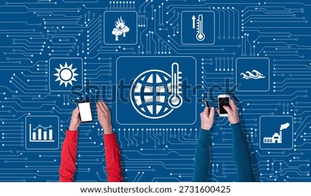 Top view of hands using mobile phone with symbol of global warming concept