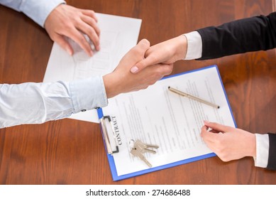 Top view of handshake of a real estate agent and a client. - Shutterstock ID 274686488