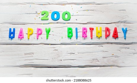 Top View Of Happy Birthday Candle Numbers Copy Space On Wooden White Pastel Boards. Beautiful Birthday Card With Number 200