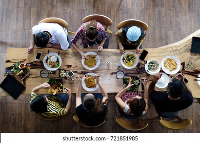 Top View Of Happy Family Gathering For Eating Food Together At  Table On Holiday, Soft Focus Background