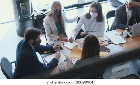 Top View Happy Multiethnic Creative Start-up Business People Wear Masks Working At Meeting At Light Modern Office Table.