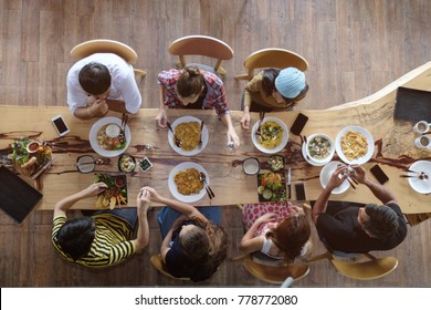 Top View Of Happy People Gathering For Eating Food Together And Enjoying The Party And Communicate With Family And Friends At Table On Holiday, Soft Focus Background