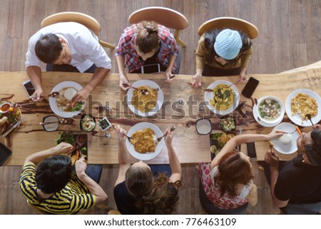 Similar – Image, Stock Photo Young friends looking map with healthy drinks and snacks