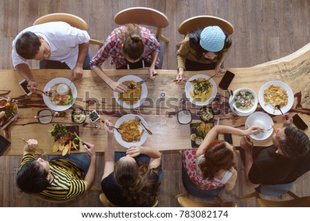 Similar – Image, Stock Photo Young friends looking map with healthy drinks and snacks