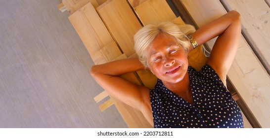 Top View Of Happy Senior Woman Lying At Wooden Boards, Wide Photography. Copy Space.