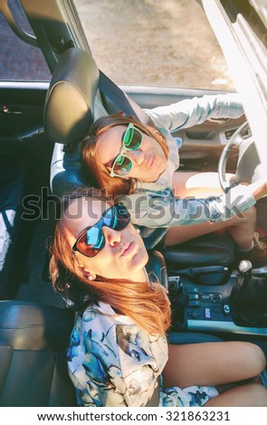 Similar – Two young women resting sitting inside of car