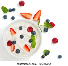 Top View Of Healthy Greek Yogurt In A Bowl With Fresh Berries Isolated On White Background.