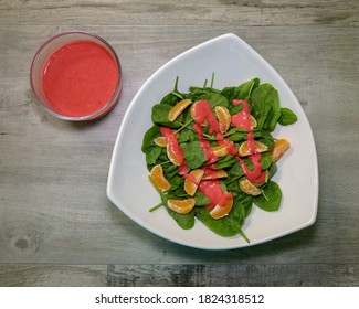 Top View Of A Healthy Spinach Salad With Mandarin Oranges And Raspberry Vinaigrette Dressing.