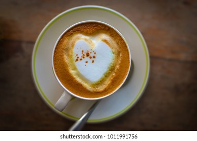 Top view Heart Shape Coffee Cup Concept on wooden table background