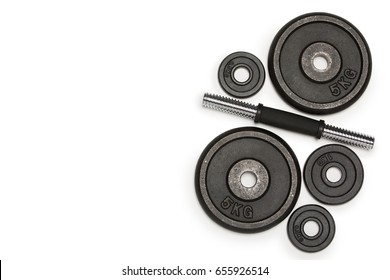 Top View Of Heavy Weight Plates With Iron Bar Isolated On White