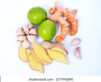 Top view of herb vegetables with lemons lime citrus, turmeric, ginger and garlic isolated on white background.