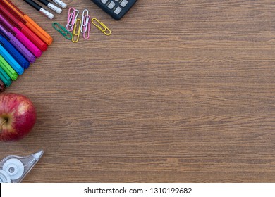 Top View High Angle Back To School Still Life On Top Of A Wood Teachers Desk, Note Pads, Pencils And Erasers With Copy Space Flat Lay.