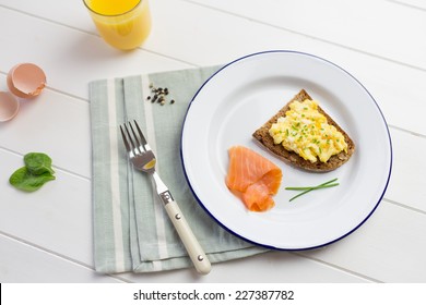 Top View Of High Protein Breakfast With Eggs And Salmon On White Wooden Background