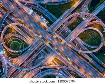 Top view of Highway road junctions at night. The Intersecting freeway road overpass the eastern outer ring road of Bangkok, Thailand.