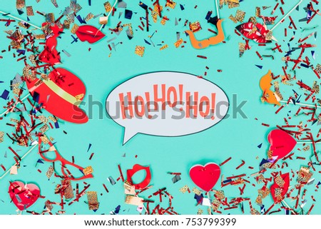 top view of hohoho speach bubble with confetti isolated on green