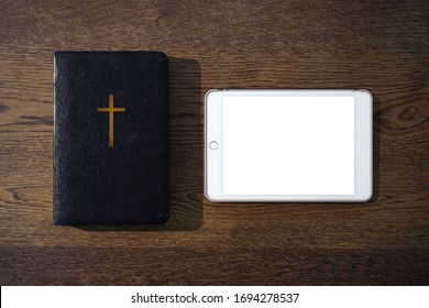 Top view of holy bible with blank tablet on wooden table, Church online Sunday  services new normal concept, Home church during quarantine coronavirus Covid-19, Study bible worship online concept